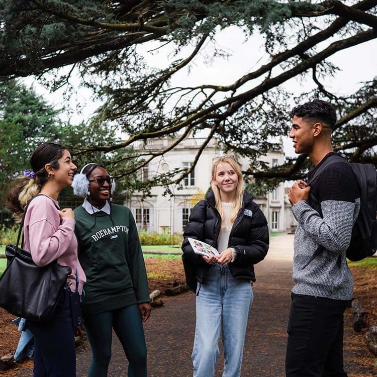 Students chatting under a tree in Froebel College