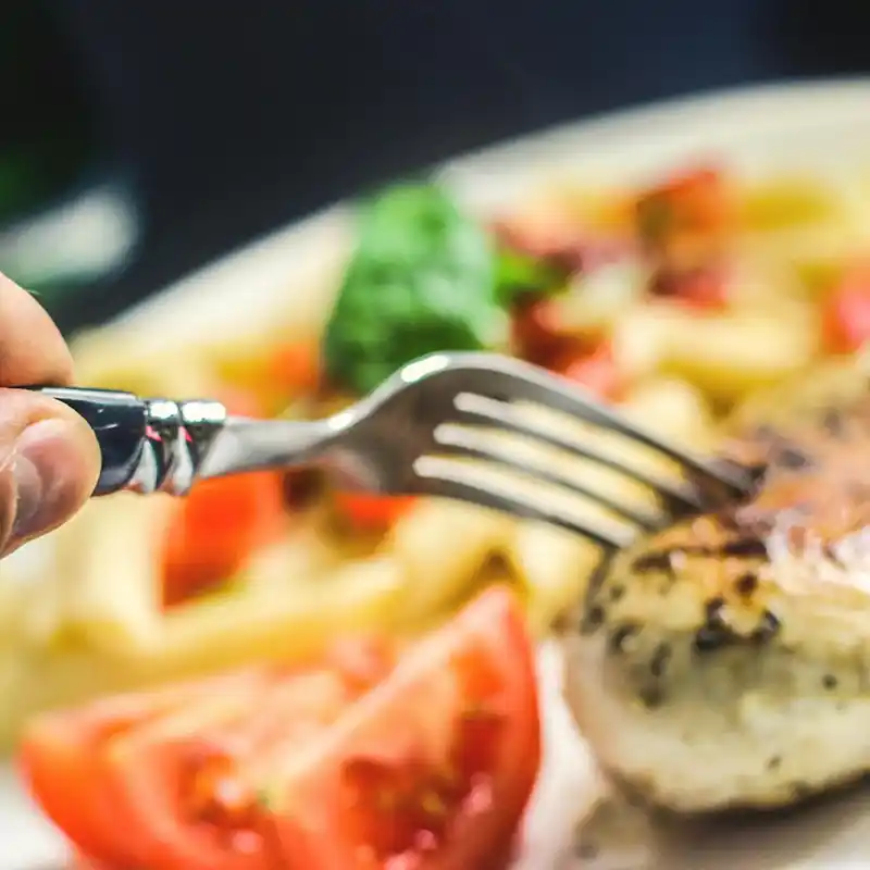 Fork taking food from plate