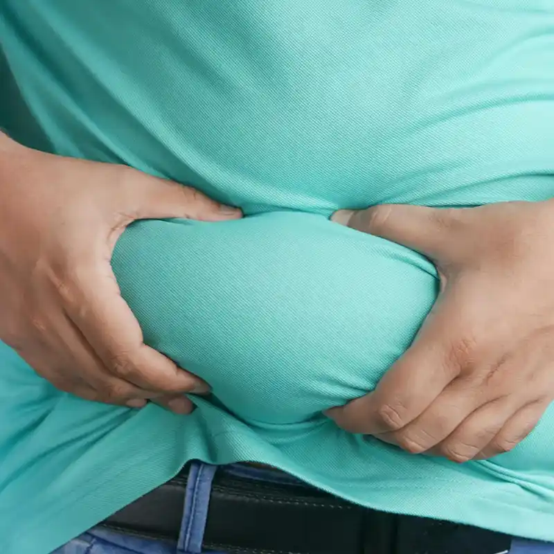 man squeezing belly