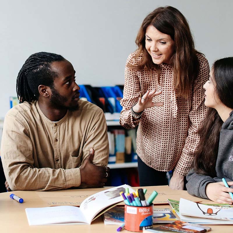 Lecturer talking to students in class